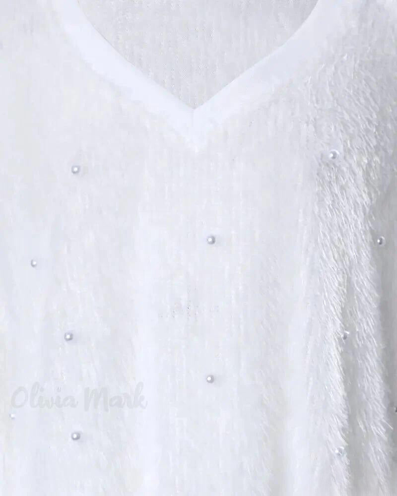 Magdalena | Jersey de punto con cuello de pico y perlas